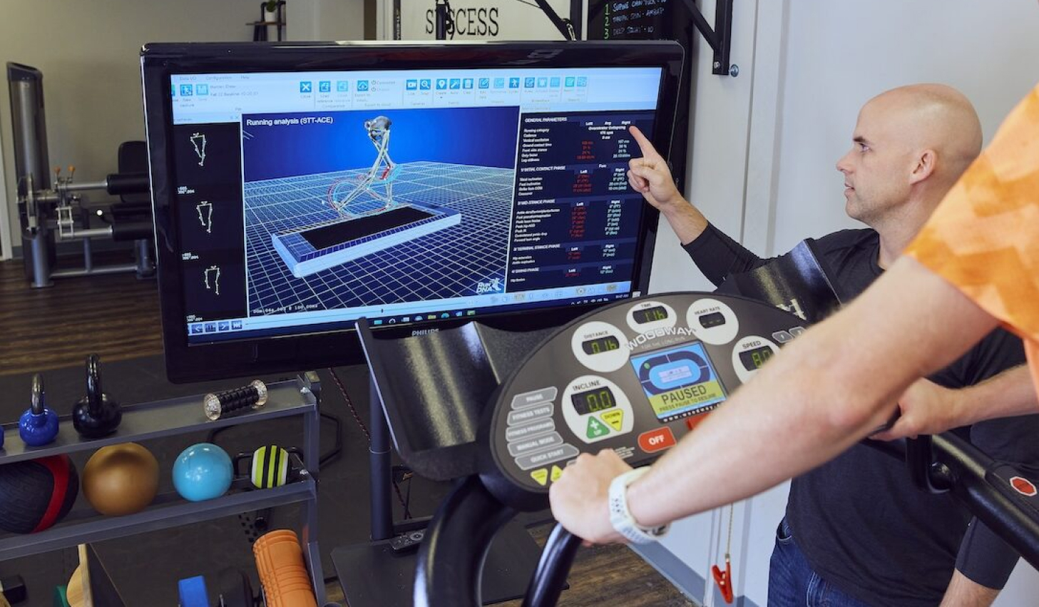Runner undergoing gait analysis in a lab to customize their strength training program for optimal performance.