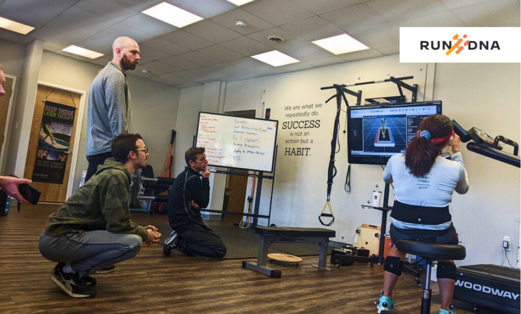 Physical therapist analyzing runner's gait using advanced technology.